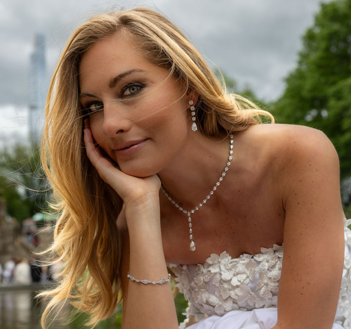 Graduated Round Diamonds and Pear Dangling Earrings